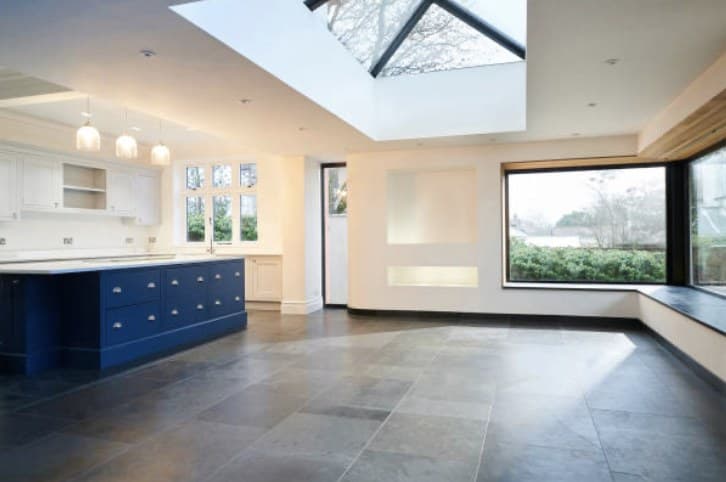 Finished modern kitchen and living extension with warm lighting and garden views